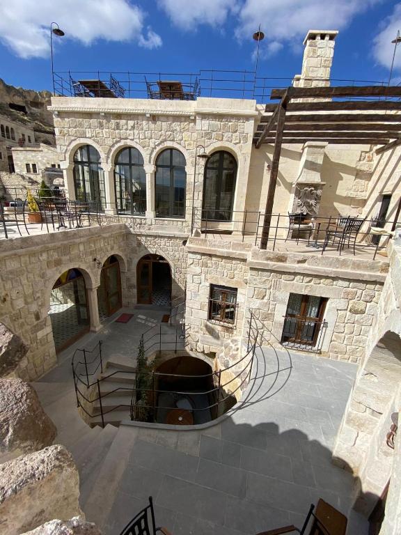 a large stone building with a large courtyard at Ürgüp Cave Suites in Ürgüp