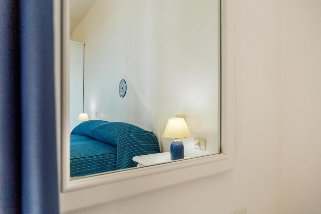 Postel nebo postele na pokoji v ubytování Hotel Agugliastra