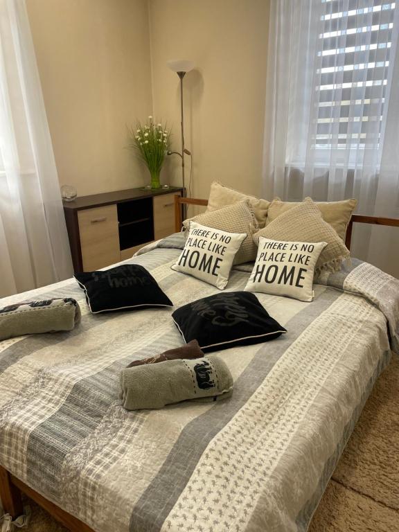 a bed with pillows on it in a bedroom at Apartament "Marka" in Piła