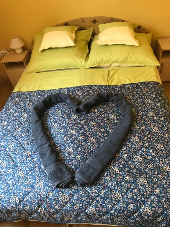 a heart shaped blanket laying on a bed at Gemini apartman in Hajdúszoboszló