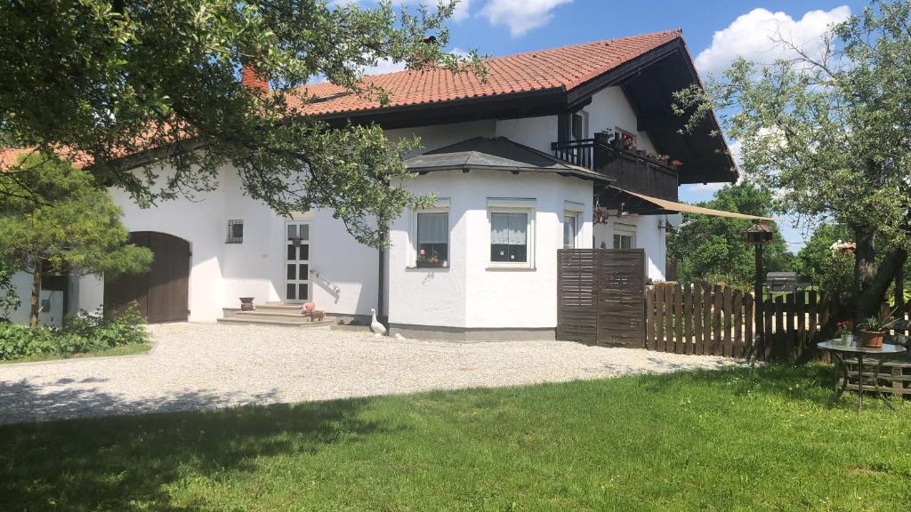 a white house with a fence and a yard at Casa Boebelle 3 km von der Therme Bükfürdö in Bük