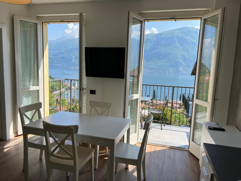a dining room with a table and chairs and a balcony at The view apartment 2 in Bellagio