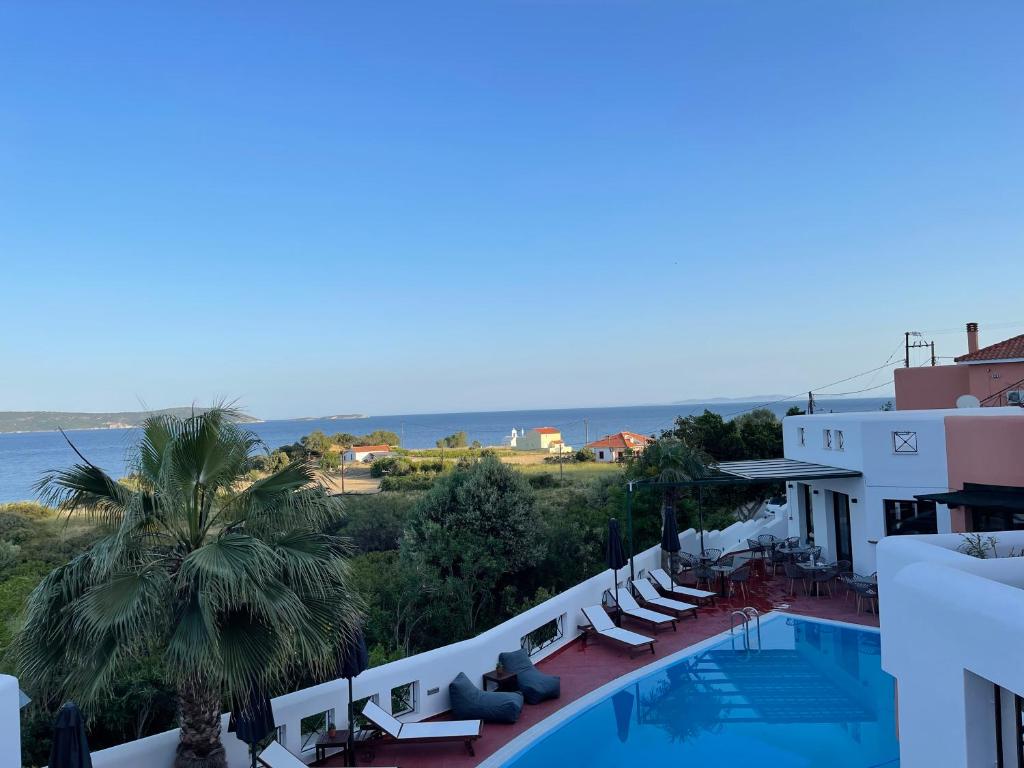 a view of a hotel with a swimming pool and the ocean at Nisea Hotel Samos in Pythagoreio