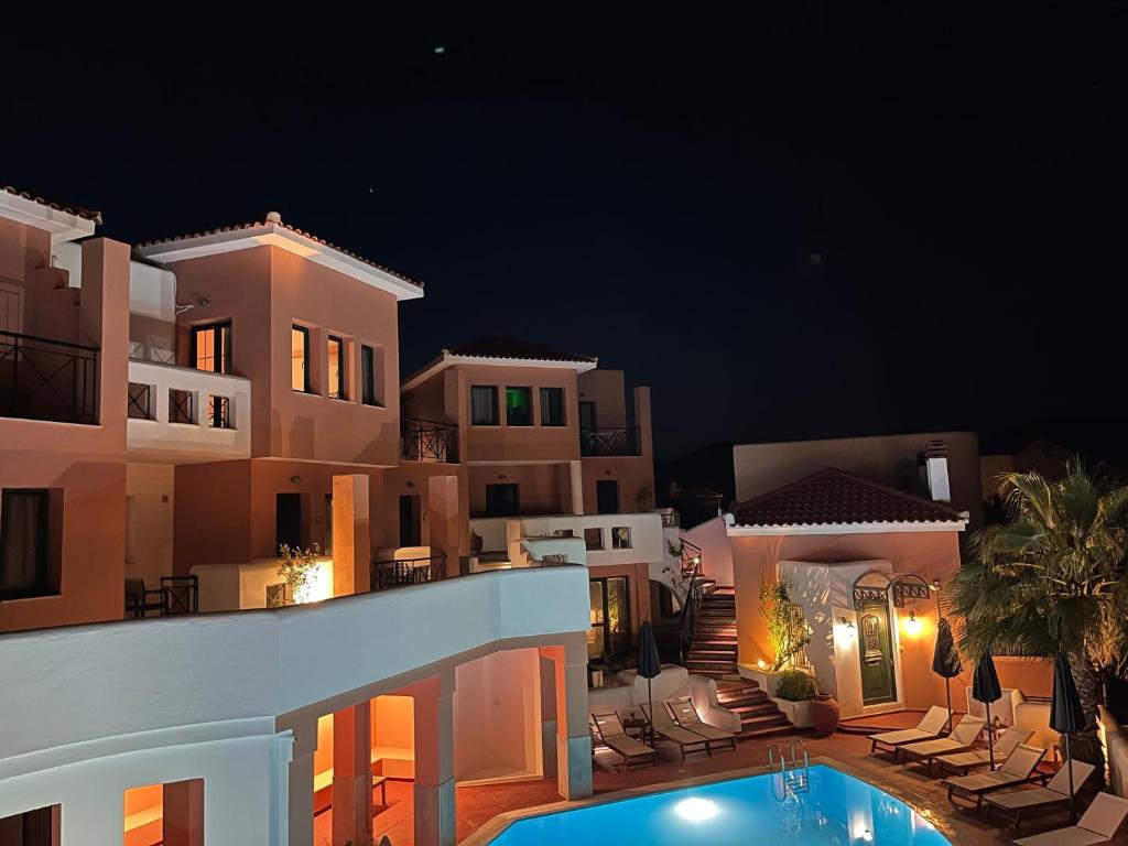 a villa with a swimming pool at night at Nisea Hotel Samos in Pythagoreio