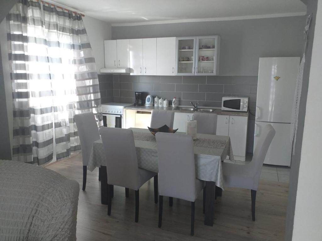 a kitchen and dining room with a table and chairs at Apartment Darinka in Šibenik