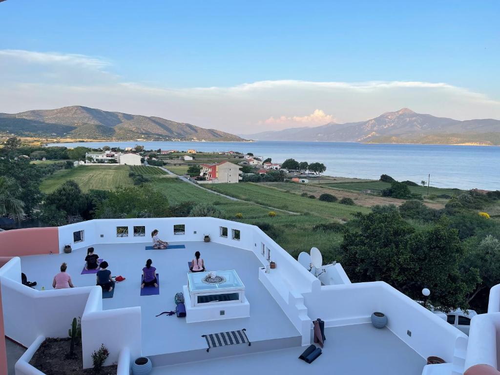 a view from the balcony of a house overlooking the water at Nisea Hotel Samos in Pythagoreio