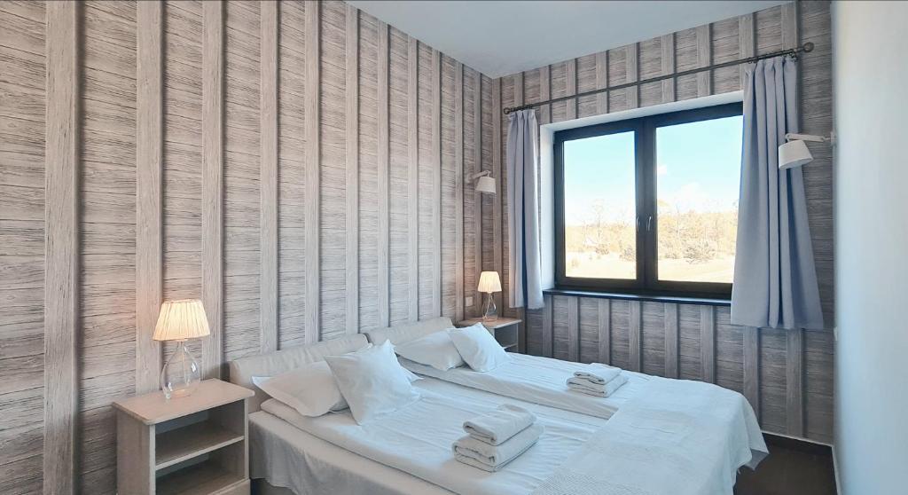 Posteľ alebo postele v izbe v ubytovaní Apartamenty Sasinówka