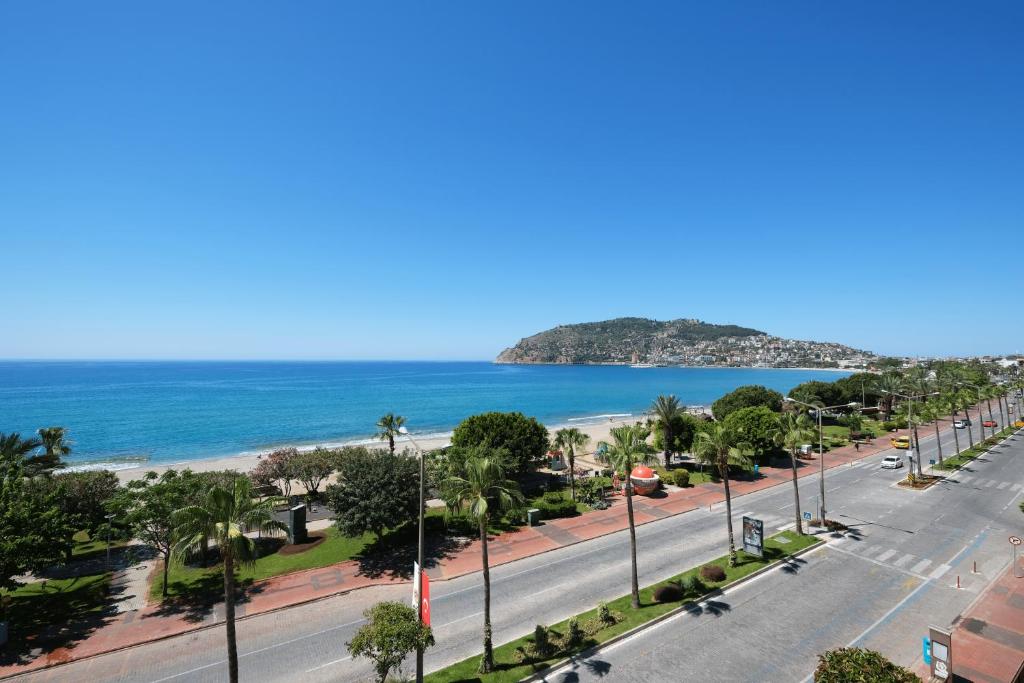 a view of a street with a beach and the ocean at Wien Star Hotel in Alanya