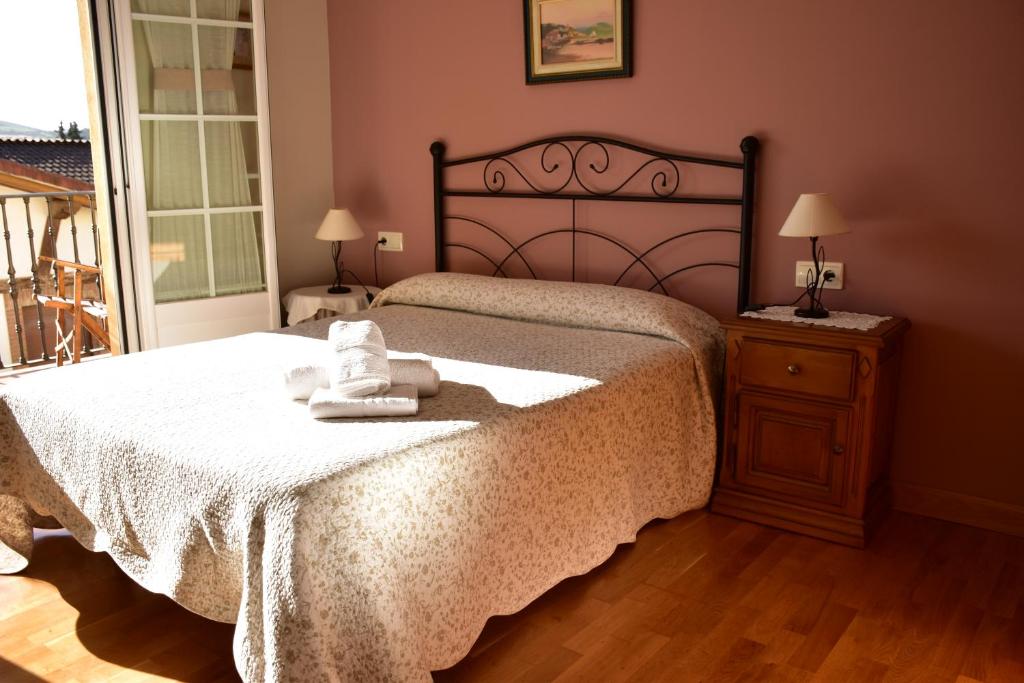 a bedroom with a large bed and a wooden floor at CASA RAICHU in Obanos