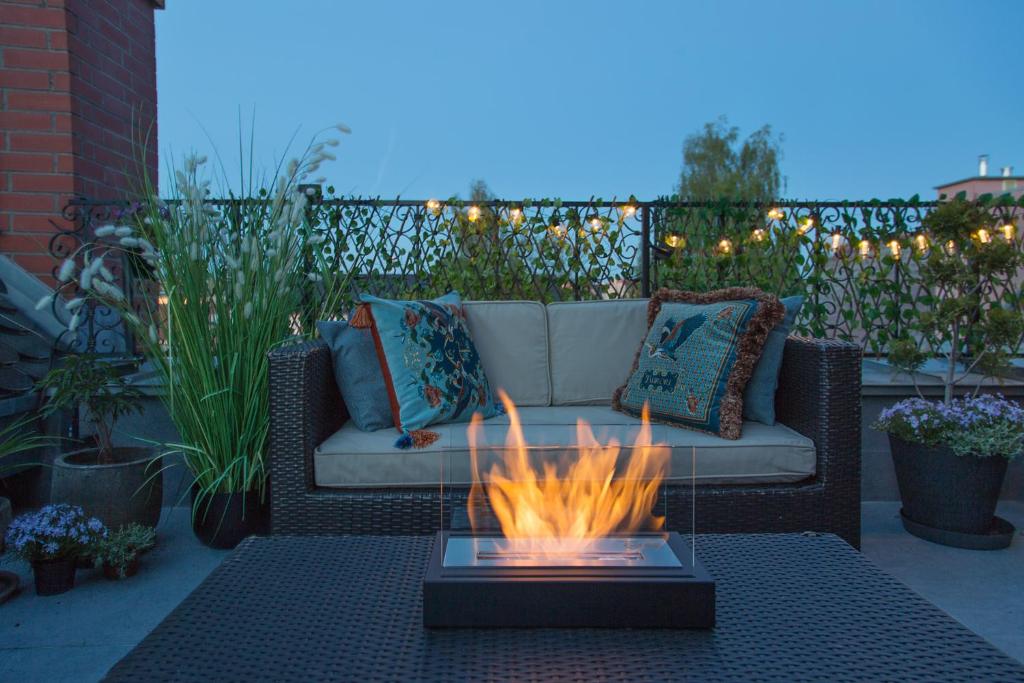 a patio with a couch and a fire pit at Loft Barnim in Szczecinek