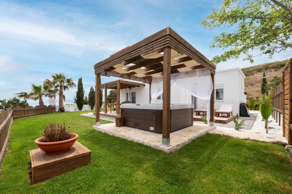 a gazebo with a bed in a yard at Alta Vista 2 Luxury House in Kardamaina