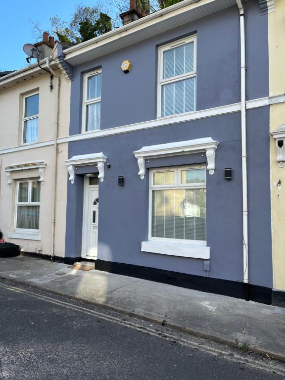 a blue house on the side of a street at Town House,Walking Distance To Beach,Town,Harbour in Torquay