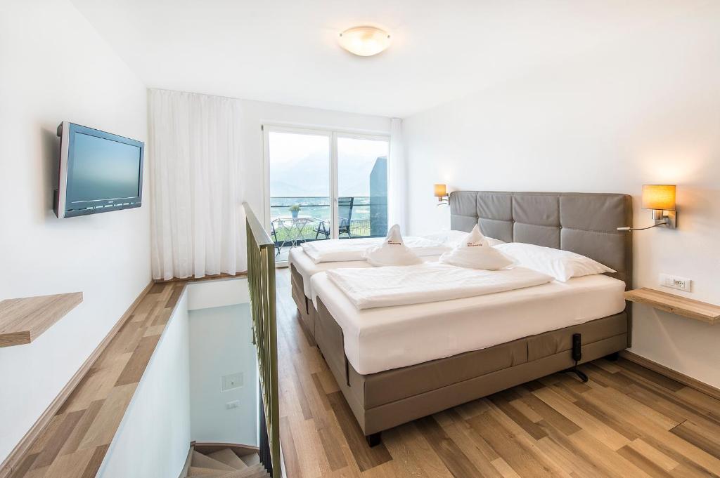 Postel nebo postele na pokoji v ubytování Hotel Appartements Graf Hartwig