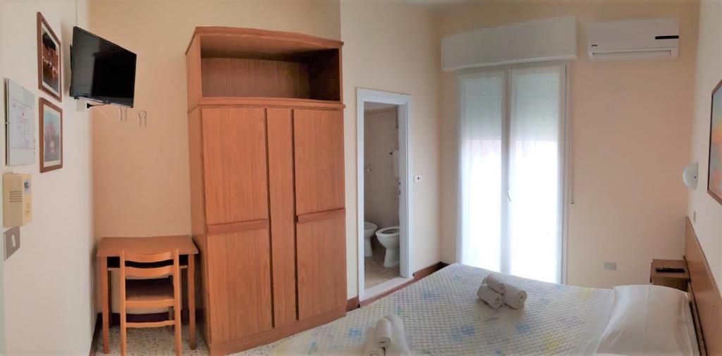Postel nebo postele na pokoji v ubytování Hotel Amalfi