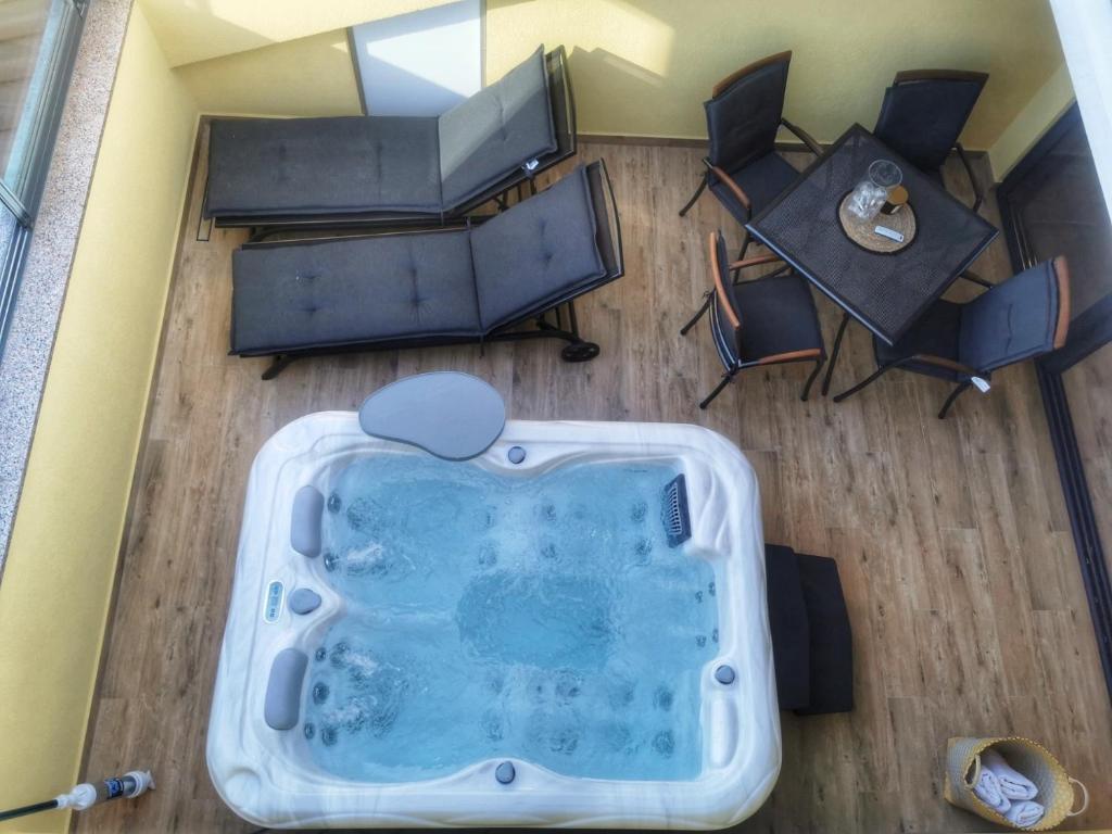 an overhead view of a hot tub in a living room at Apartments Nina in Rab