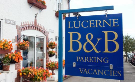 a blue sign in front of a building at Lucerne B&B in Lyme Regis