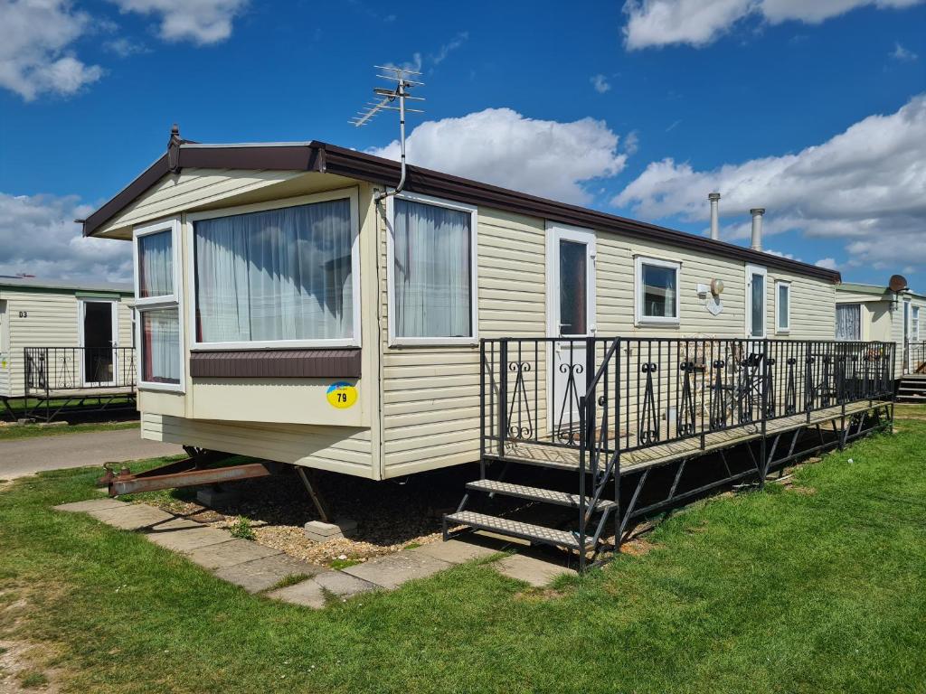 a mobile home with a porch and a balcony at 6 Berth Seaview Ingoldmells Park Lodge in Ingoldmells