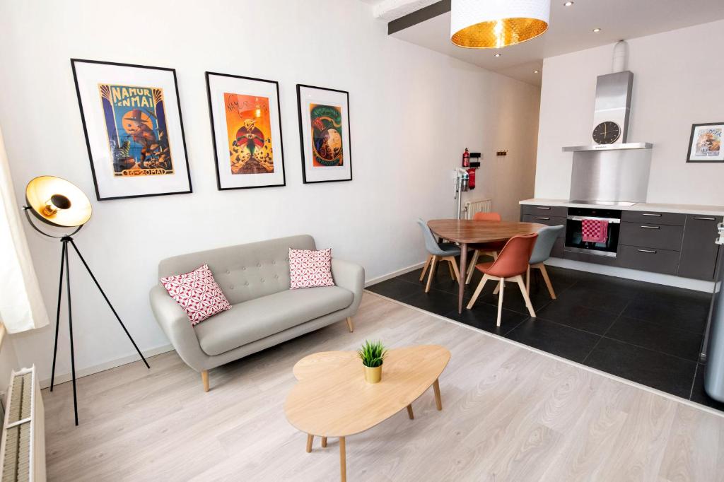 a living room with a couch and a table at Les Cerisiers - Appart de Standing à Namur Centre in Namur