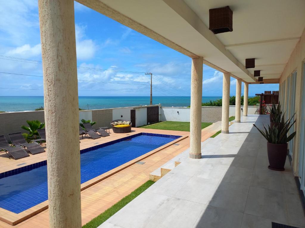 a swimming pool on the roof of a house at Vilamar in Tibau do Sul