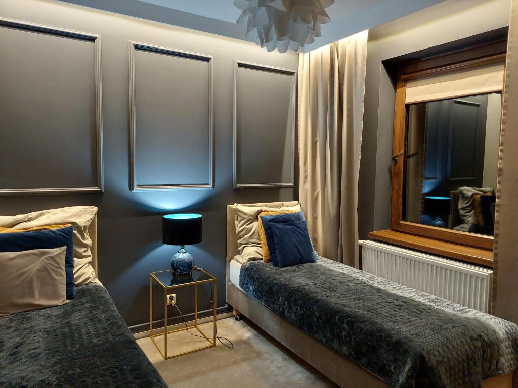 A bed or beds in a room at Nowoczesne domki z kominkami, sauną i fotelem masującym Bayamo, Lucca, Hawana I i Hawana II