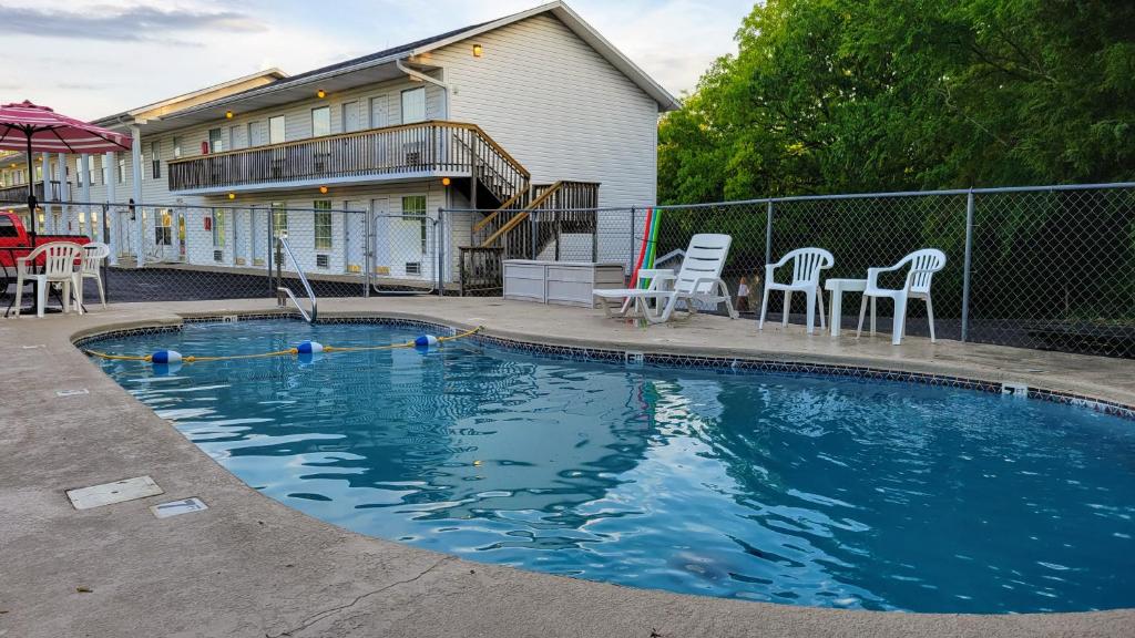 a swimming pool in front of a house at Autumn Creek Branson in Branson