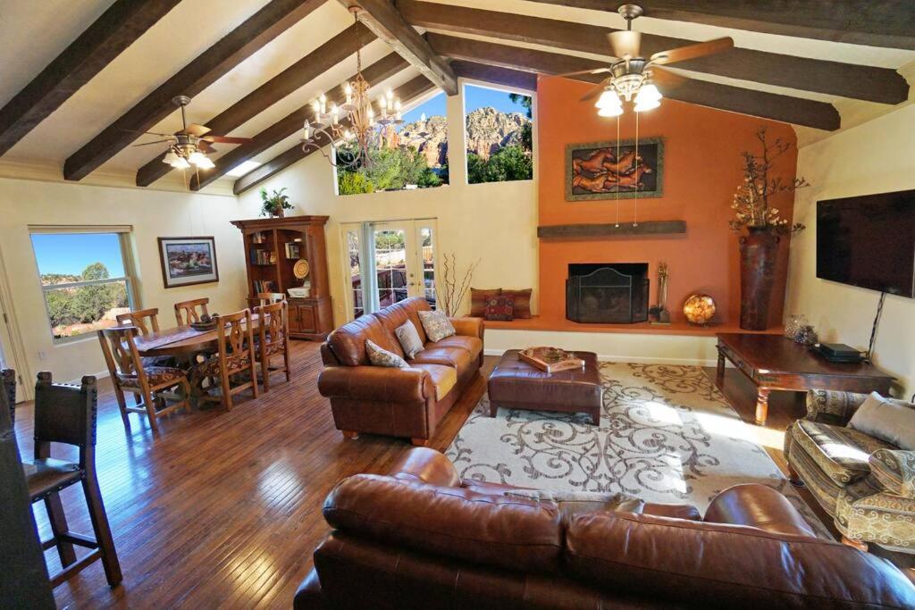 a living room with leather furniture and a dining room at Sedona Quail Hollow Retreat in Sedona