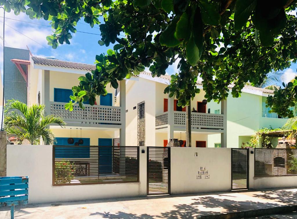 a house with a fence in front of it at Casa Azul Home Stay in Porto De Galinhas