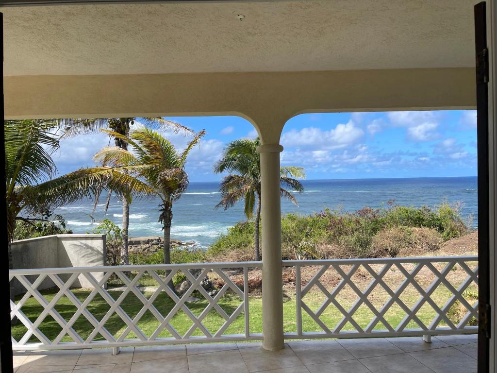 a view of the ocean from a balcony at ‘MORIAH’ Private Room with Double Bed and shared bathroom in Saint Philip