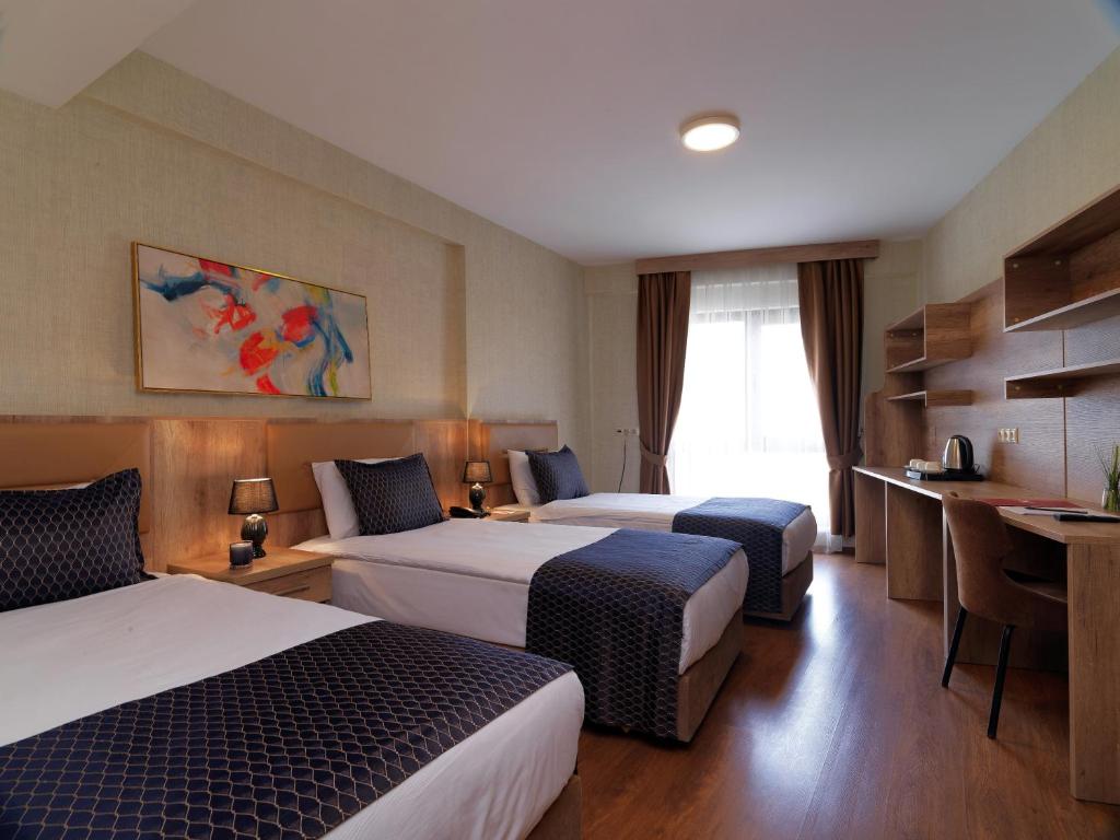 A bed or beds in a room at Jaff Hotels & Spa Nisantasi