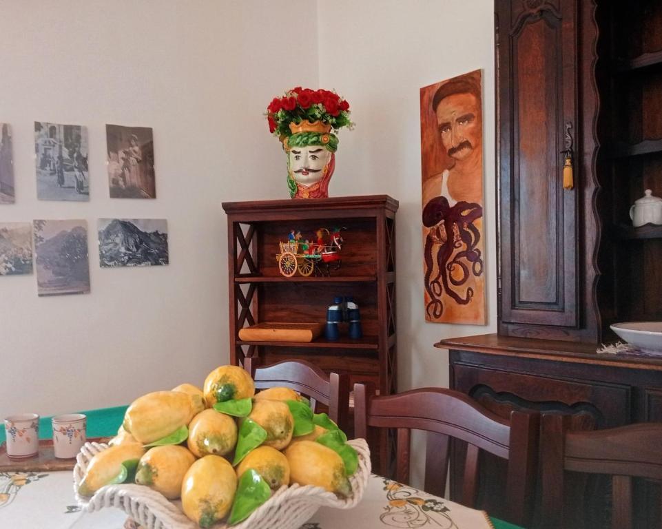 a table with a bowl of fruit on top of it at Johnny and Mary's house breathtaking view locazioneturistica in Taormina