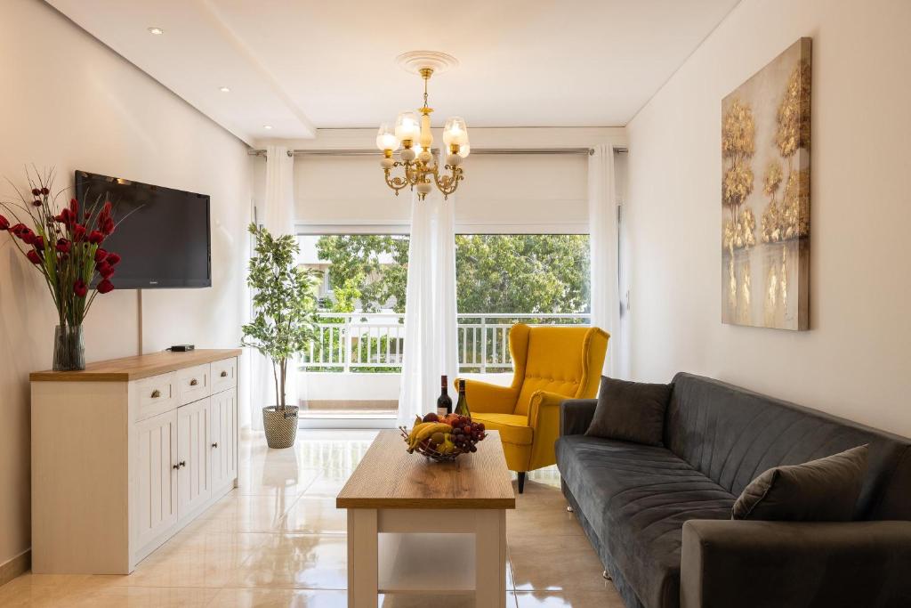 a living room with a couch and a table at Kamelia Apartment in Rhodes Town