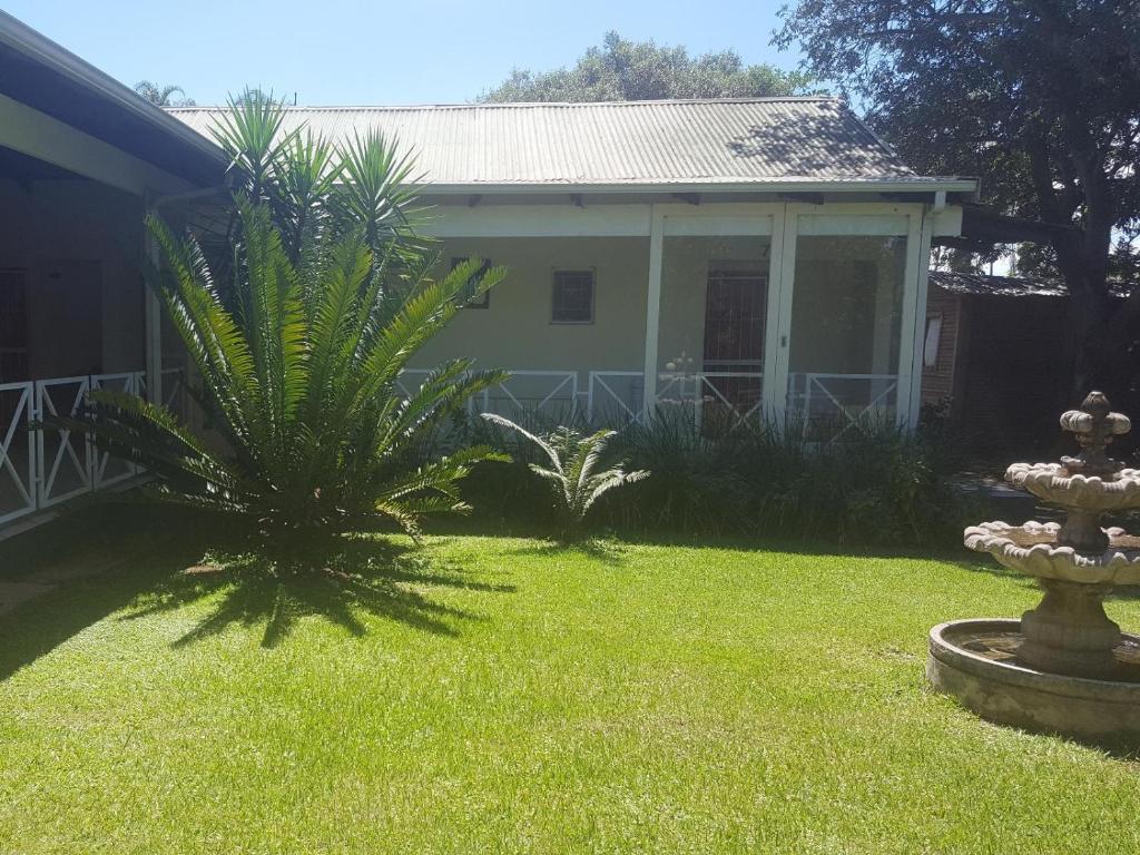 a house with two palm trees in a yard at Alexandra Bed & Breakfast in Pelham