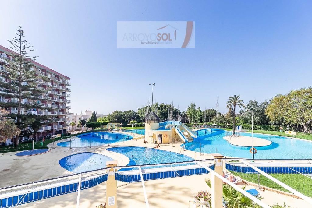 a large swimming pool with a slide in a park at Alpa Minerva in Benalmádena