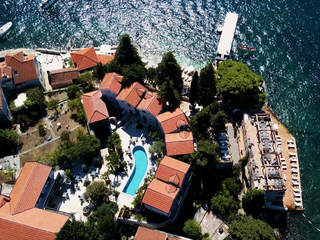 an aerial view of a house by the water at Forte Rose Resort in Tivat