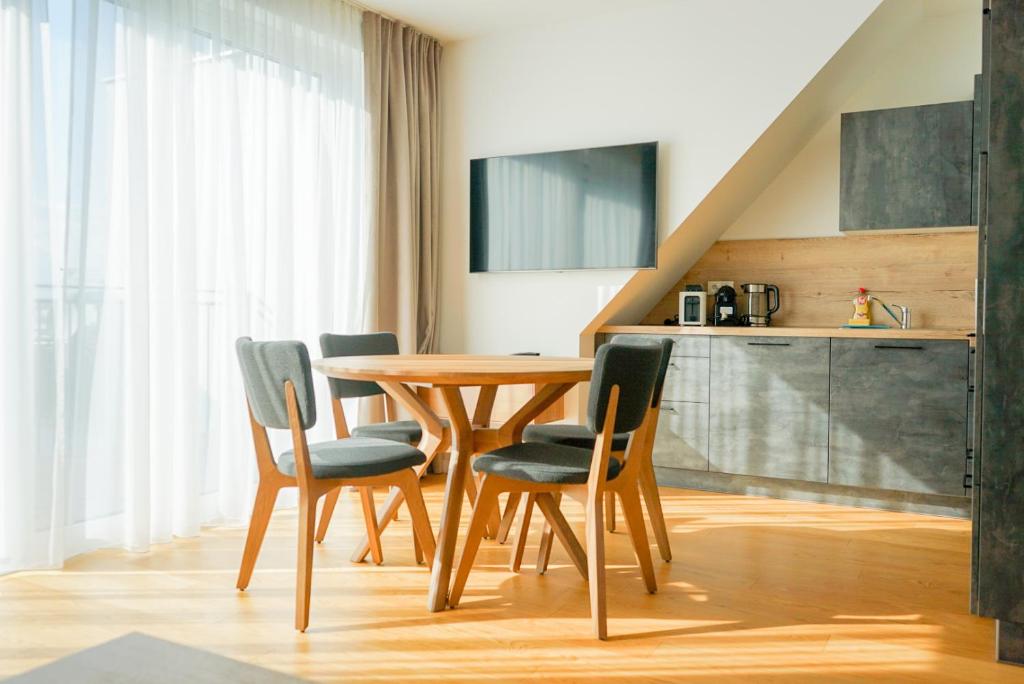 a dining room with a wooden table and chairs at Nadland Apartments B61 in Vienna
