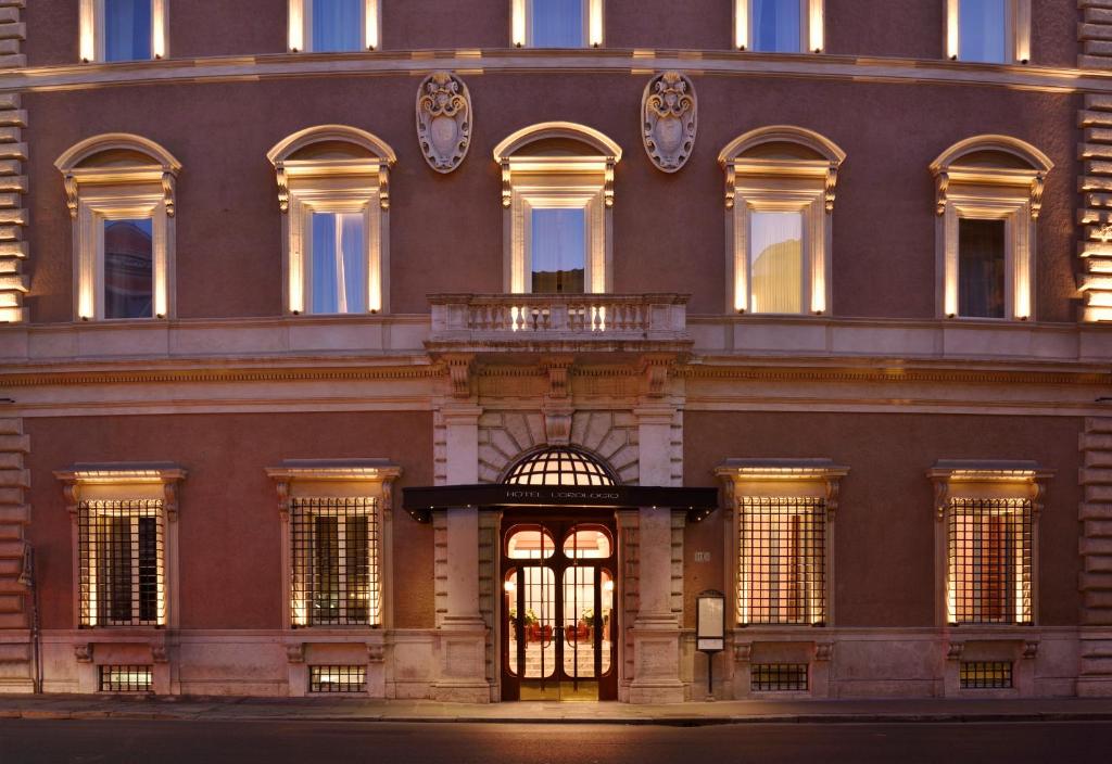 a large building with many windows and a balcony at Hotel L'Orologio Roma - WTB Hotels in Rome