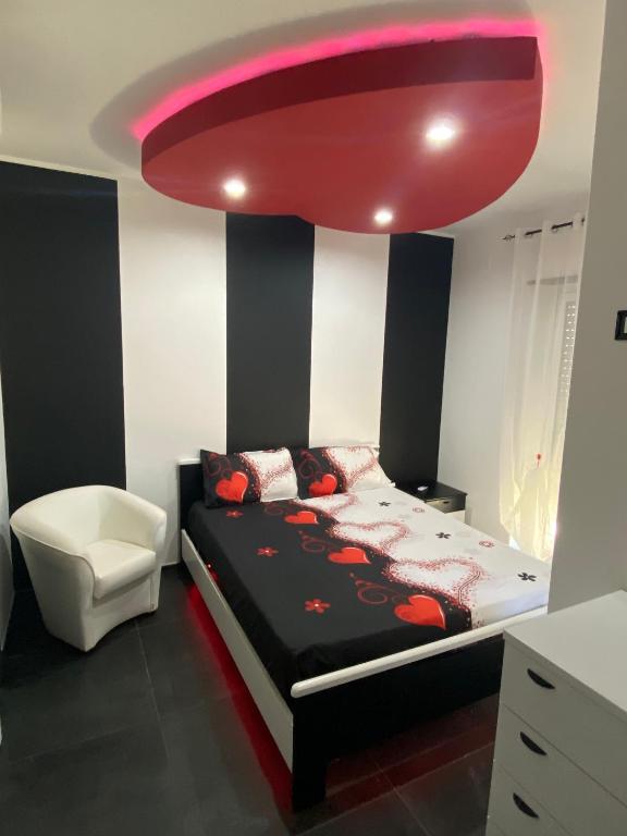 a bedroom with a bed and a pink ceiling at IRIS ROOM in Monopoli