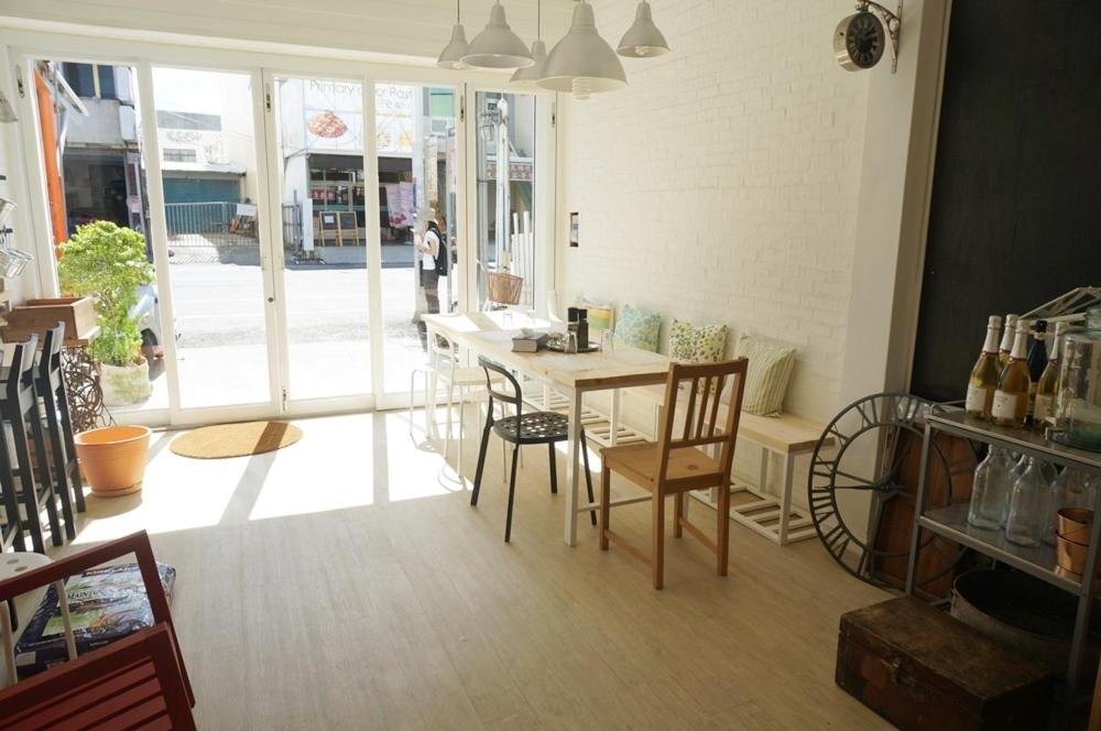 a room with a table and chairs in a store at Milk White Homestay in Hengchun South Gate