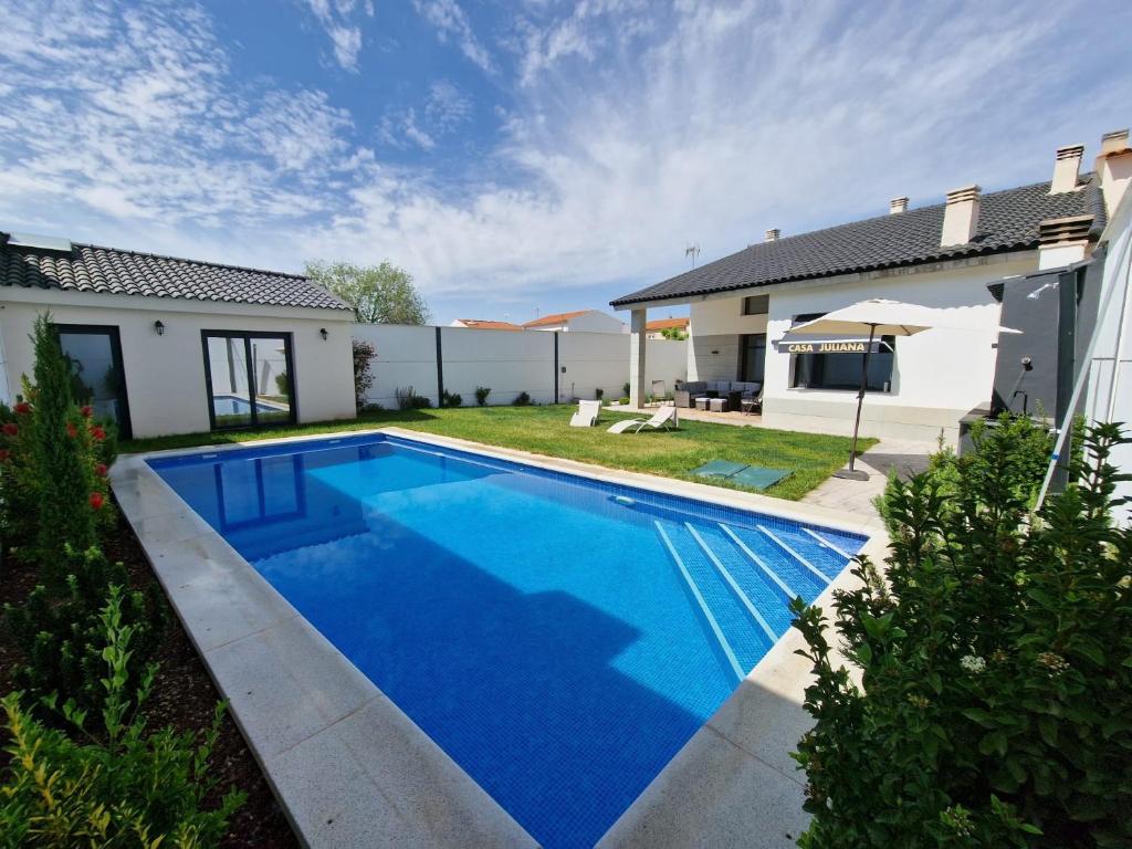 a swimming pool in the backyard of a house at Casa Juliana in Herencia