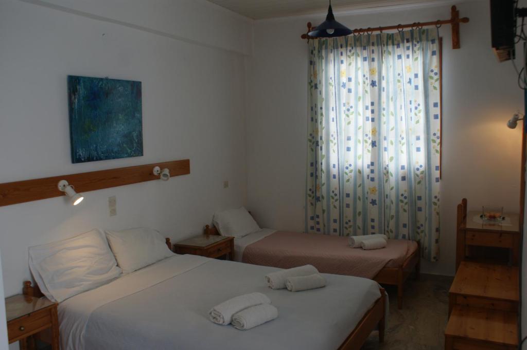 Postel nebo postele na pokoji v ubytování Hotel Eleftheria