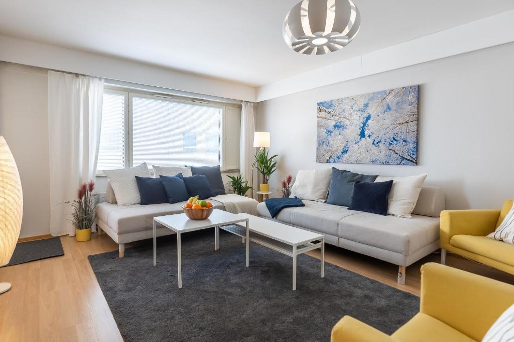 a living room with a couch and a table at City Holiday Apartments 1 in Rovaniemi