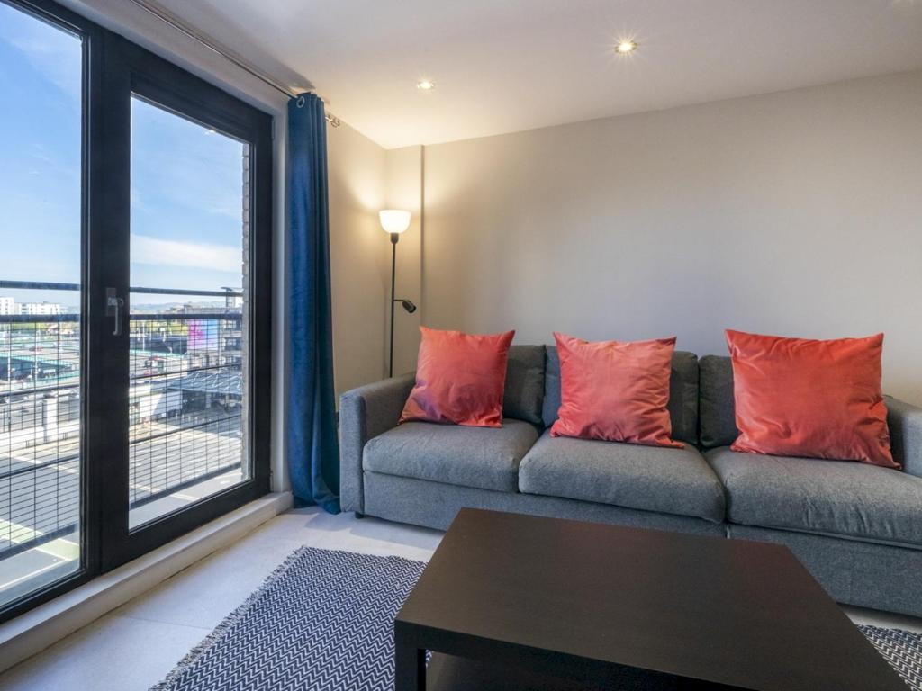 uma sala de estar com um sofá e uma grande janela em Pass the Keys Stunning 1BR Apt in No 1 Location with Free Parking em Belfast