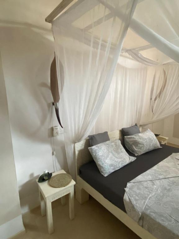 Postel nebo postele na pokoji v ubytování Watamu Shell House