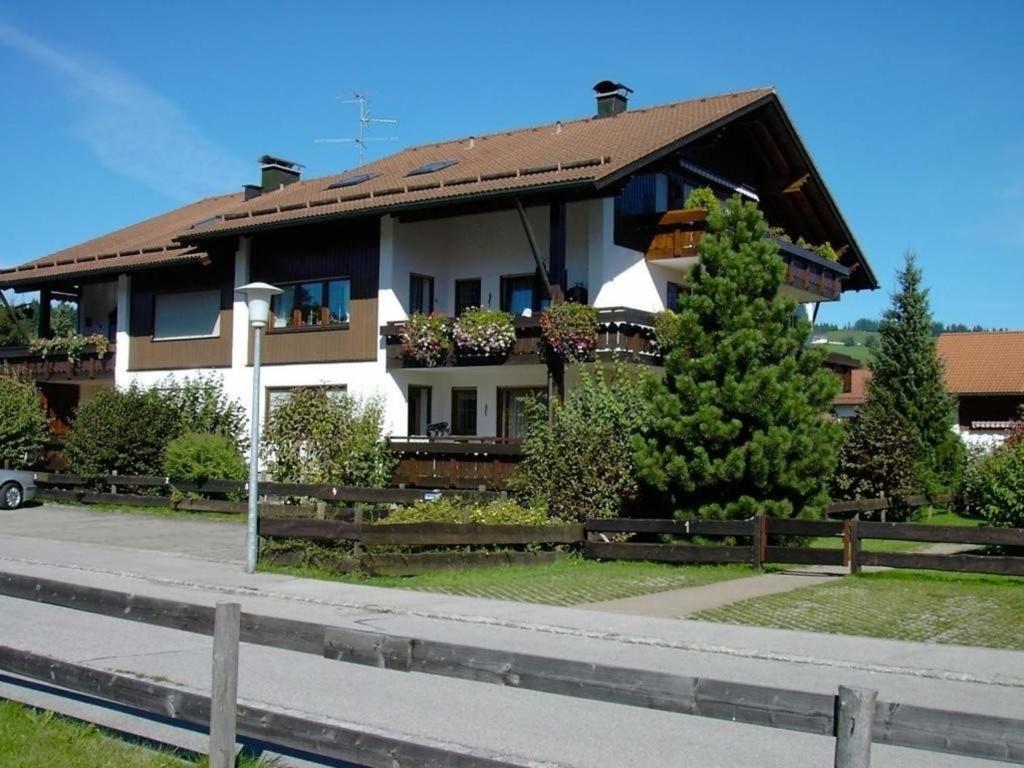 a white house with a brown roof at Haus Grüntensee in Wertach