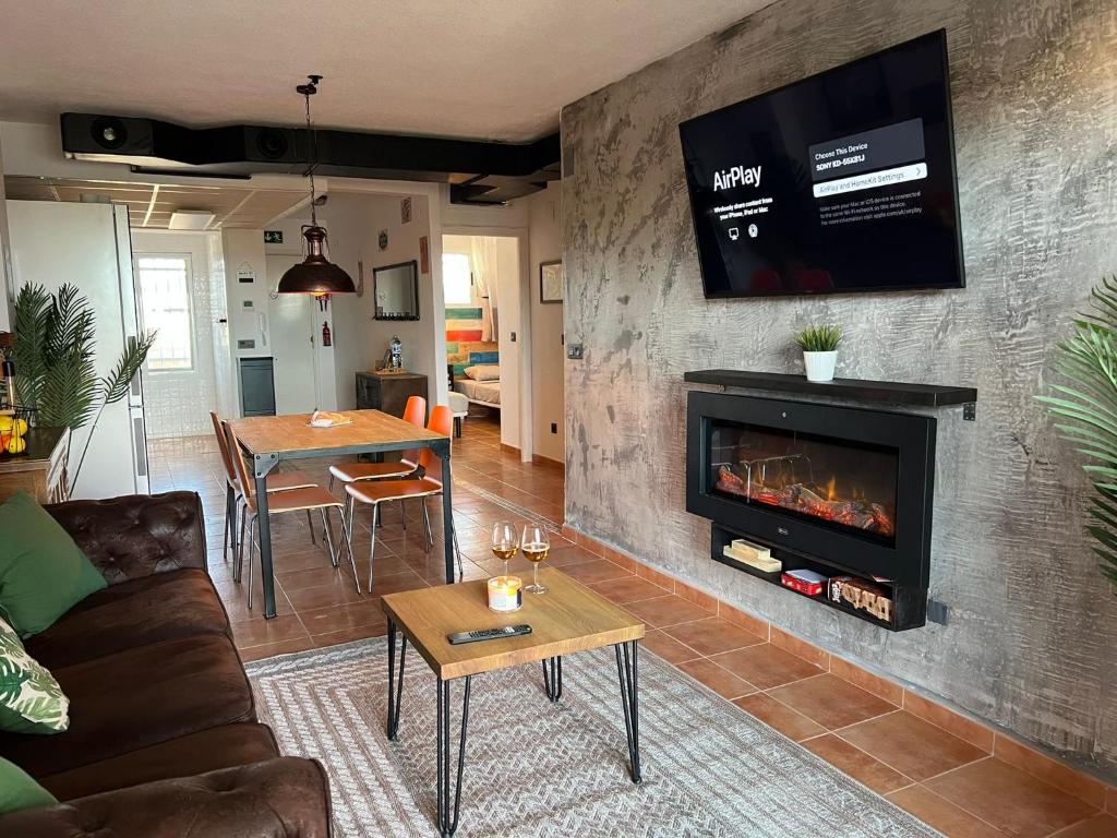 a living room with a couch and a fireplace at Los Nietos Apartment in Los Nietos