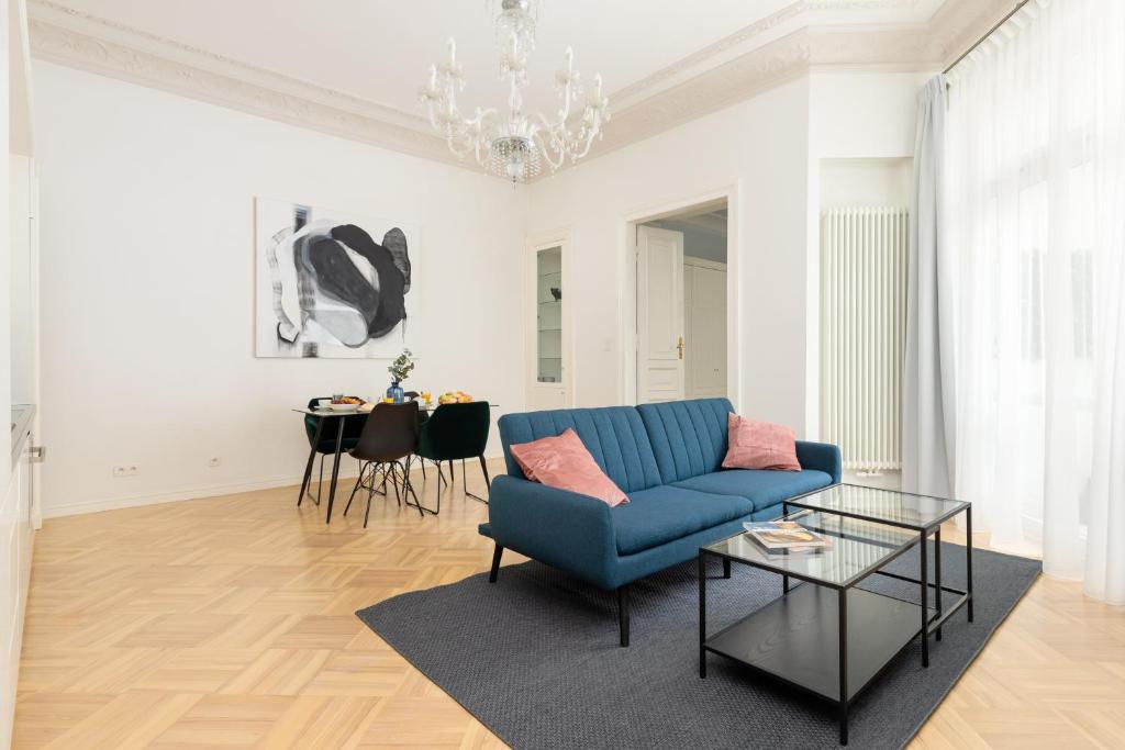 a living room with a blue couch and a table at Rent like home - Marszałkowska 58 in Warsaw
