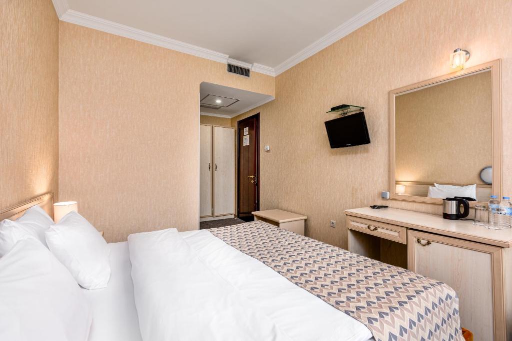 Postel nebo postele na pokoji v ubytování Sharden Hotel