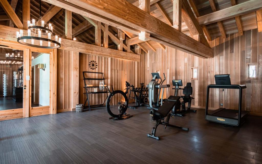 a gym with bikes and exercise equipment in a room at Hôtel LE BLIZZARD in Val-d'Isère