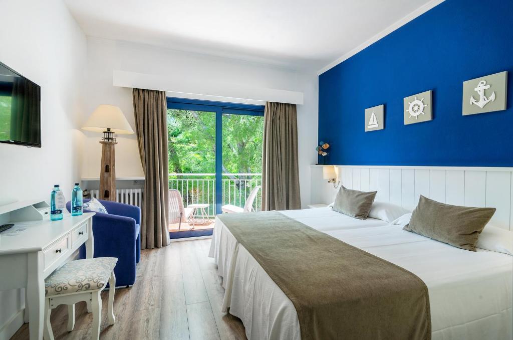 Postel nebo postele na pokoji v ubytování Hotel Garbi