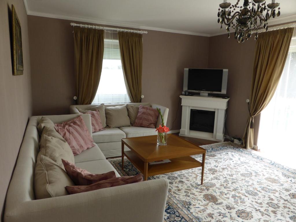 a living room with a white couch and a table at Apartment Elena in Bad Wörishofen